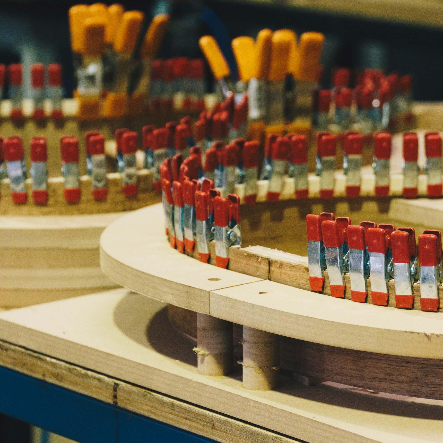 Weissenborn guitar being made in Richard Wilson guitar factory with multiple red mini clamps