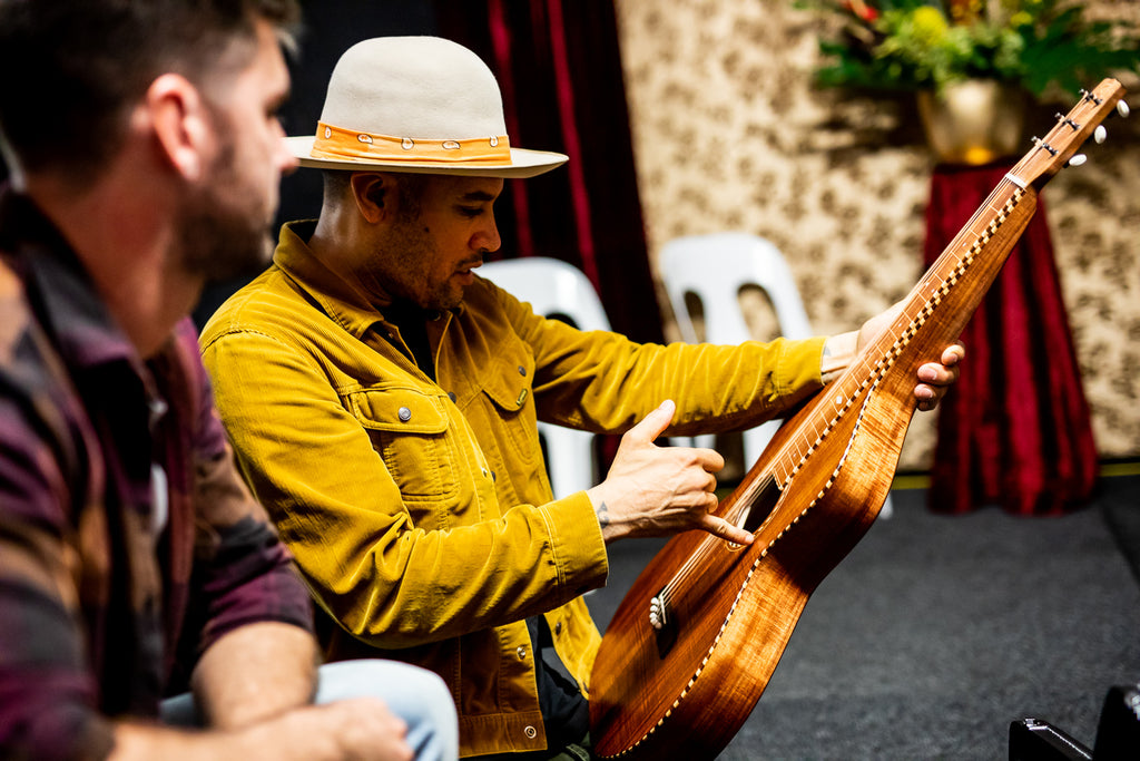 Ben Harper admiring rope binding on Richard Wilson's Style 3 Weissenborn Guitar at Bluesfest 2019