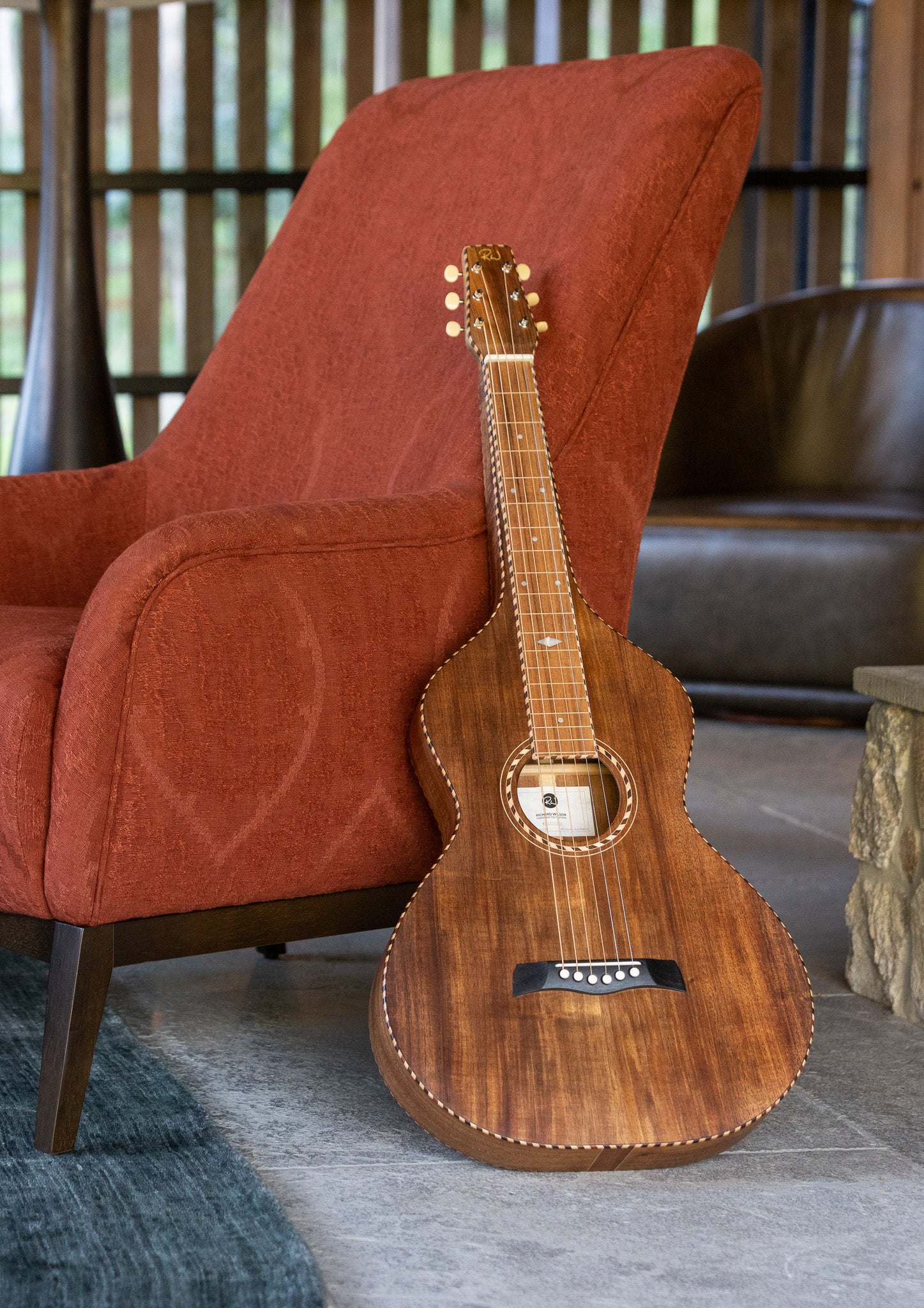 Style 4 Weissenborn Lap Steel Slide Guitar styled on red chair in modern country home