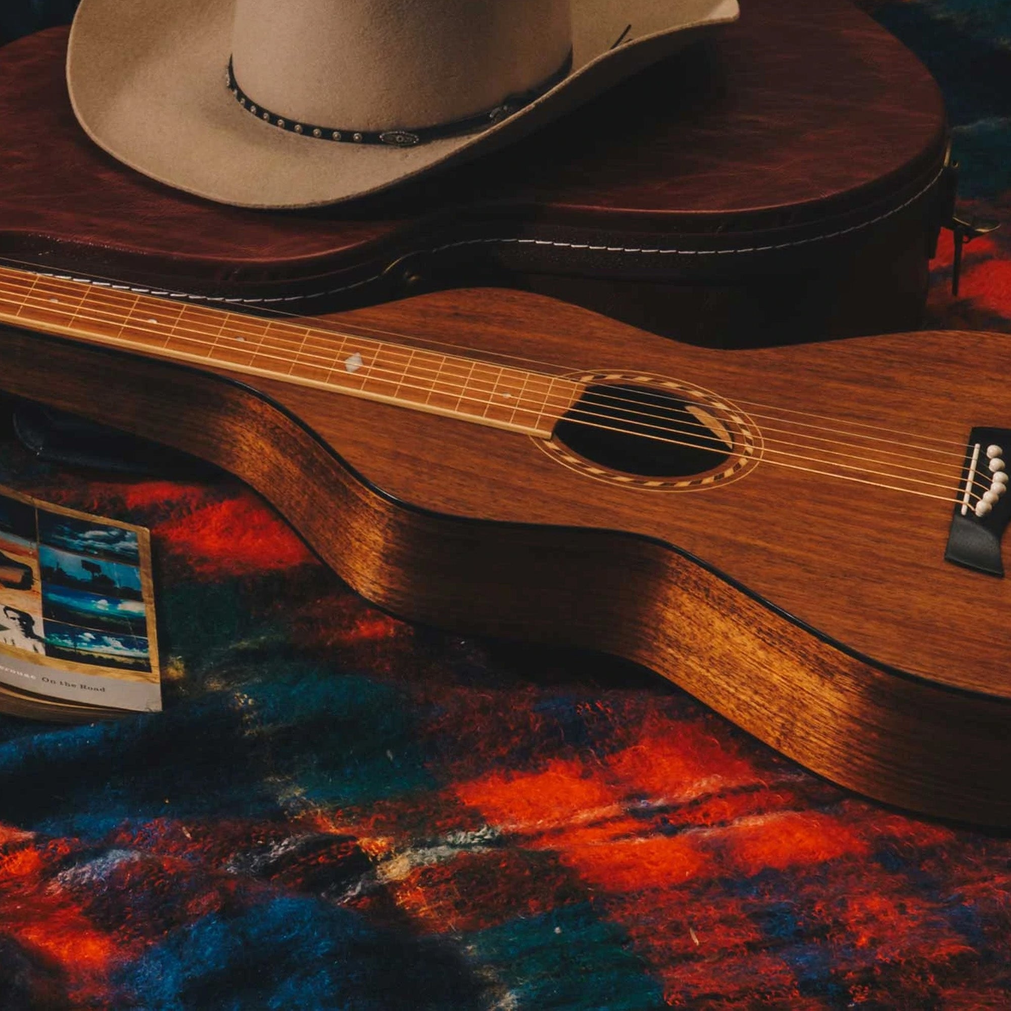 Style 2 Richard Wilson Weissenborn guitar on a picnic rug with a cowboy hat